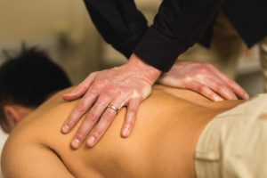 Physiotherapist massaging patient's back